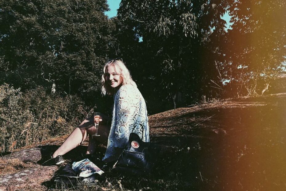 Natalie Skogman sitter på en klippa i solsken.